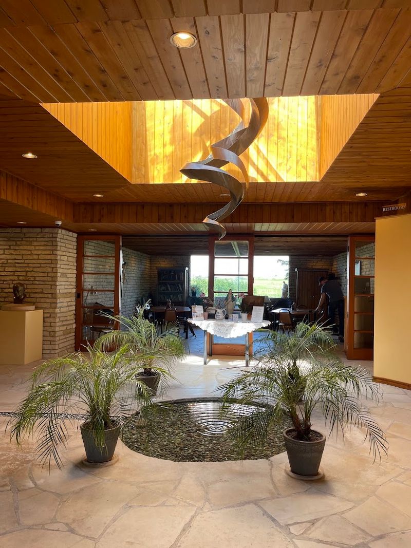 A Shroud Sculpture Hangs Beneath A Skylight