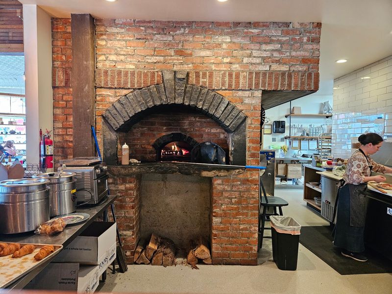This Idaho Bakery Hides Inside A 1920s Service Station With An Old Safe Turned Into An Oven - Decor Hint The Original Dealership Safe Now Forms Part Of The Wood-Fired Pizza Oven