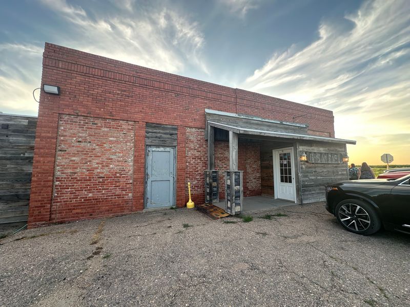 The Red-Brick Steakhouse Standing Beside Grain Bins