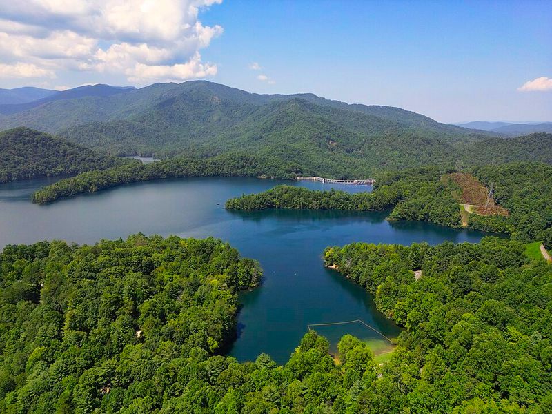 The North Carolina Lake With 76 Miles Of Mostly Undeveloped Shoreline And Barely Any Crowds - Decor Hint Watch The Mountains Reflect Across Water With Almost Nothing Built In The Way