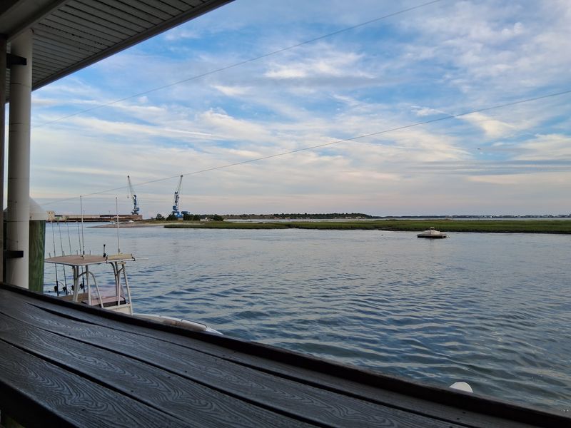 Watch Fishing Boats Move Through The Harbor While You Eat