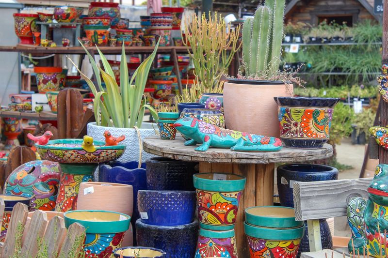 Colorful Ceramic Pots Fill The Garden In Almost Every Size