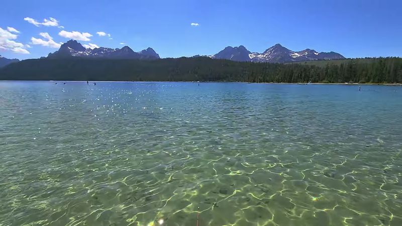 Deep In Idaho's Sawtooths Sits A Lake Where The Peaks Reflect Perfectly At Dawn - Decor Hint Colors Beneath The Surface