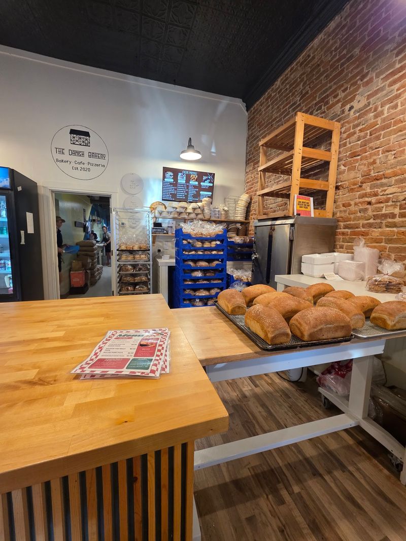 A Storefront on Mill Street With a Wall of Bread Behind the Counter