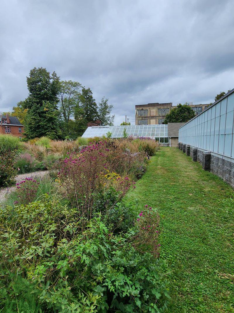 Outdoor Gardens Lead Into Six Glass Greenhouses