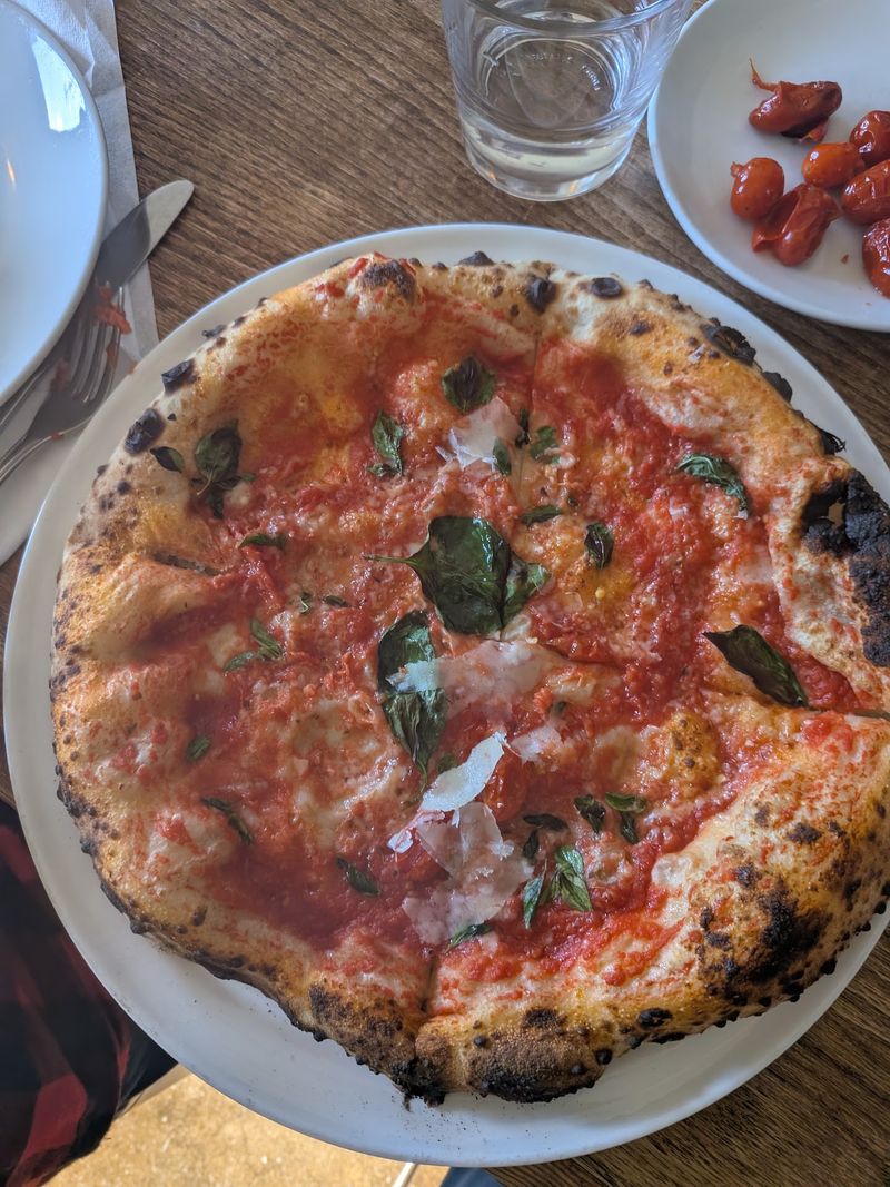 Watch Neapolitan Pizzas Take Shape Around A Blazing-Hot Oven