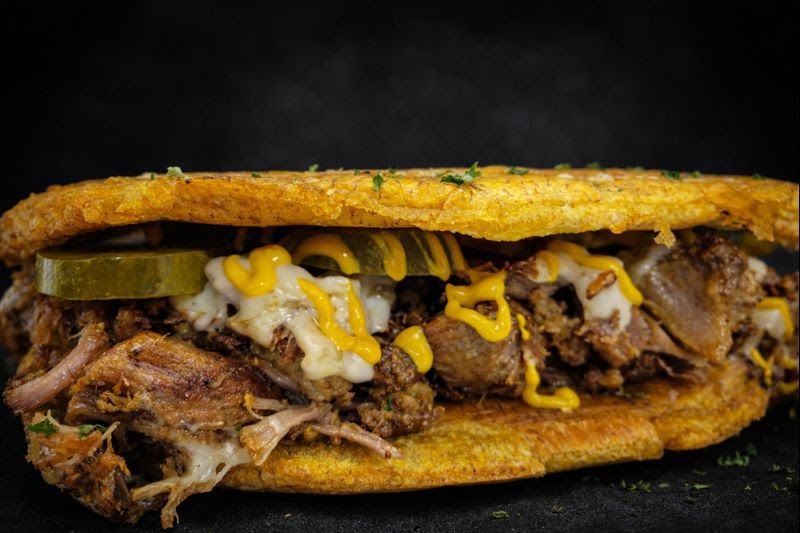 Pernil Gets Even Better When It Lands Inside A Plantain Sandwich