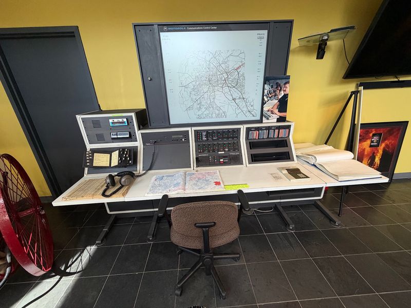 Helmets, Hoses, And A Communications Desk Worth Studying