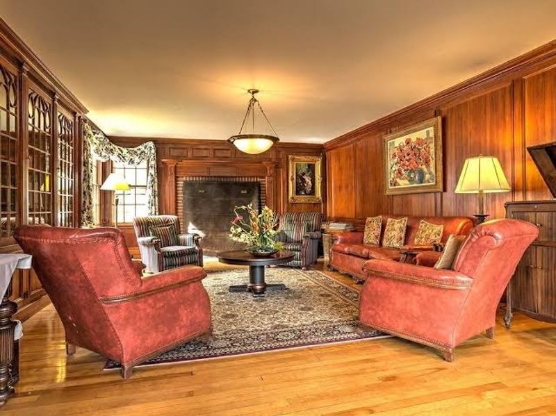 The Cherry-Paneled Library Practically Invites A Ghost Story