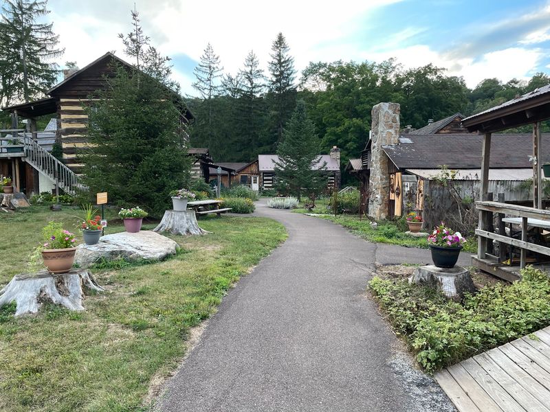 Next Door, Artists Are Hard At Work In Old Log Cabins