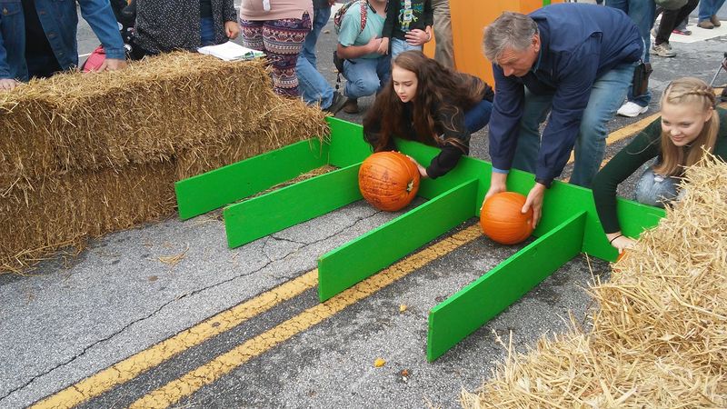 This North Carolina Town Is Celebrating 30 Years Of Rolling Pumpkins Down Main Street - Decor Hint Grab Festival Food Between Rounds Of Pumpkin-Rolling Competition