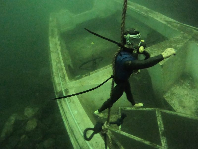 A Sailboat, A Cruiser And Other Boats Sit On The Quarry Floor