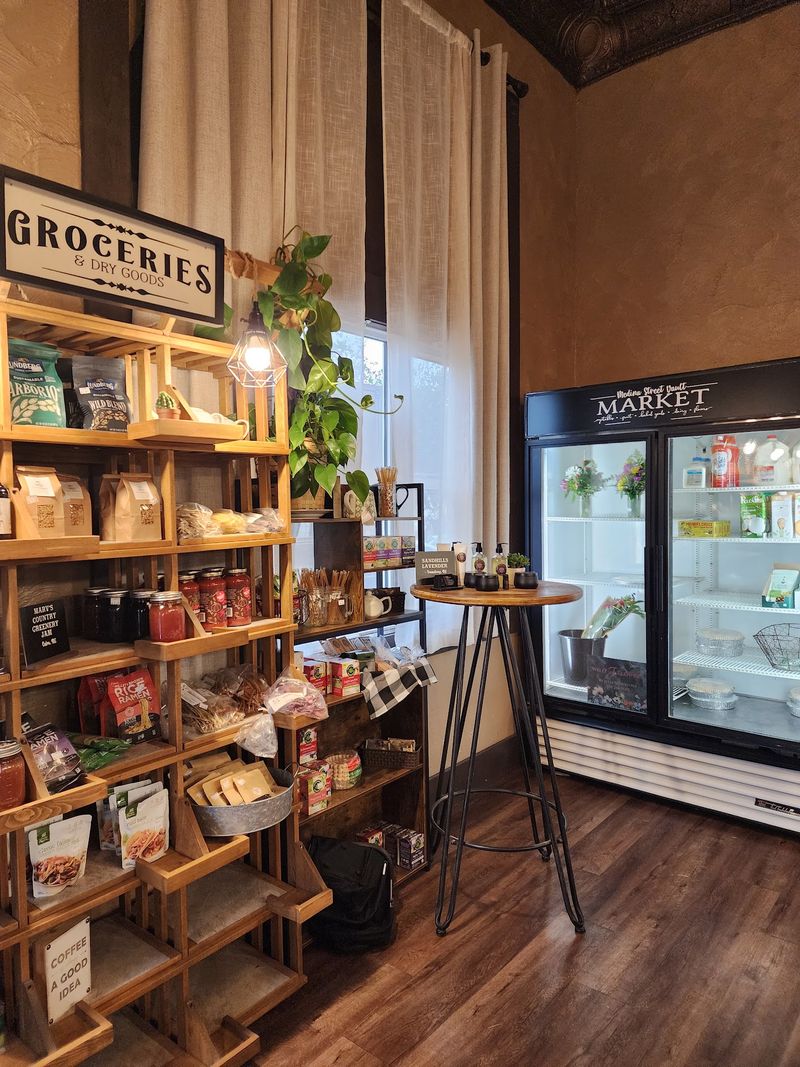 Started As A 1920s Bank, This Nebraska Building Now Pours Coffee From Inside The Old Vault - Decor Hint Local Goodies And Take-Home Treats On The Shelves