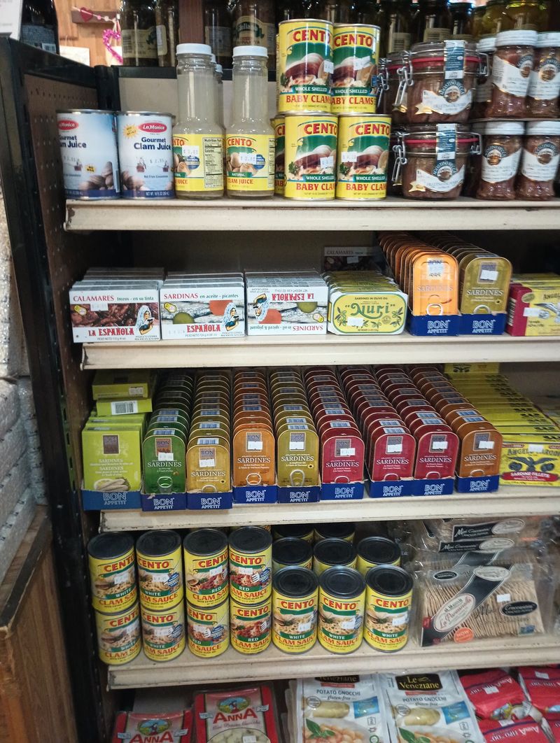 Shelves Full Of Italian Groceries Wait Past The Counter