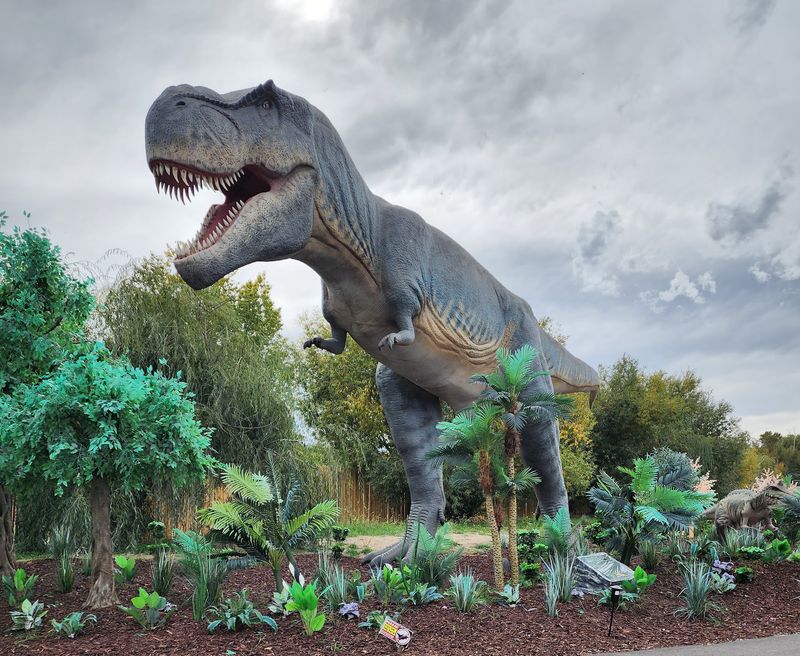 Dinosaurs Roar Along The Jurassic Creek Path