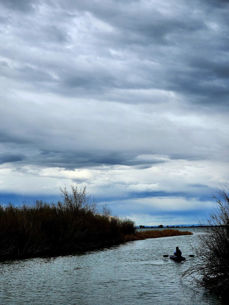 Paddling Through Marshy Channels And Open Water