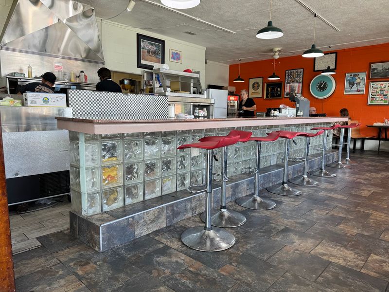 Red Stools, Chrome Shine, And Molded Booths