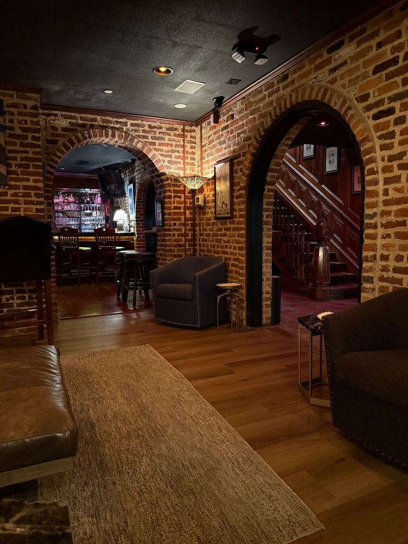 Downstairs, The Formal Mansion Turns Into A Cozy Brick-Walled Tavern