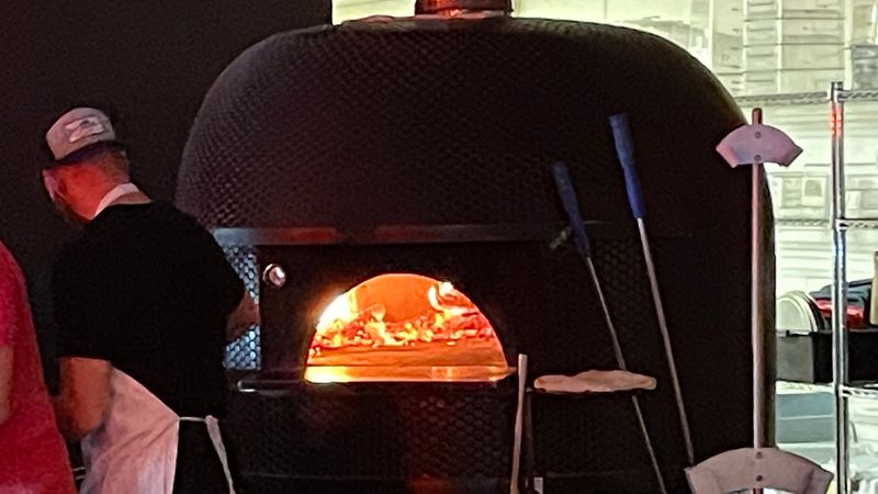 Watch Neapolitan Pizzas Hit A 900-Degree Wood-Fired Oven