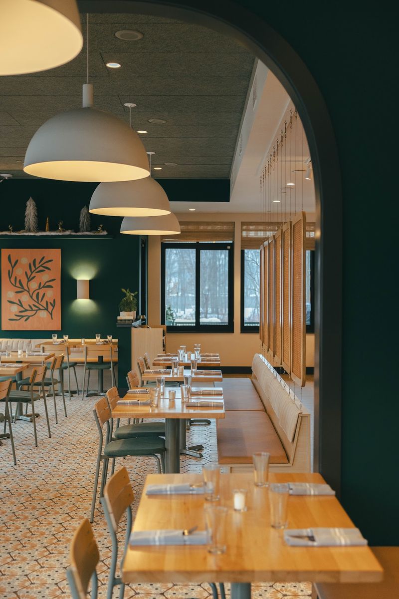 The Adventurist Says A Michelin Bib Gourmand Would Make Sense At This Michigan Pizza And Pasta Spot - Decor Hint Arches, Green Tones, And Michigan-Made Chairs Set The Mood