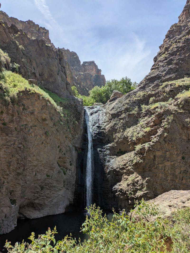 A Desert Canyon With A Waterfall Waiting At The End
