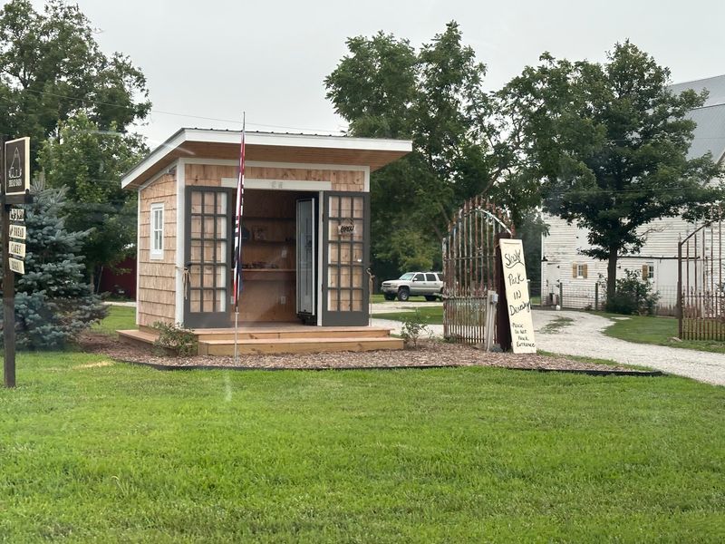 A Tiny Bake Hut Waiting At The End Of A Farm Driveway