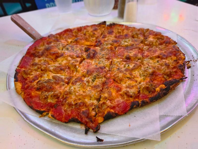 An Illinois Pizzeria Serves Cracker-Thin Tavern Squares So Crispy Locals Fight For The Corner Pieces - Decor Hint A Crust So Thin It Practically Snaps When You Lift It