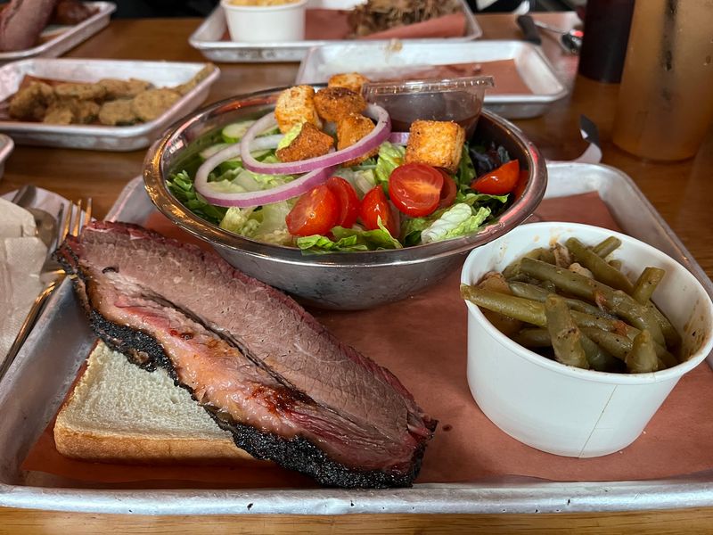 You Won't Believe How Affordable The Smoked Meat At This Georgia Restaurant Is - Decor Hint Your Brisket Plate Starts In A Smoke Hut Out Back