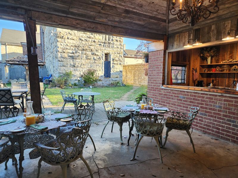 This 200-Year-Old Kentucky Jail Lets You Spend The Night Behind Bars, And Guests Say It’s Still Haunted - Decor Hint Breakfast In A Flower-Filled Courtyard Beats Prison Food Every Time